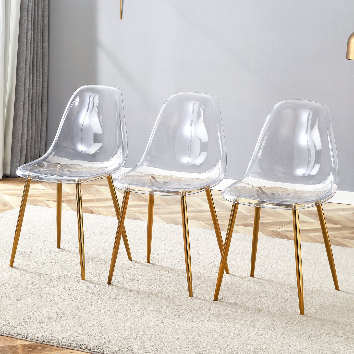 Transparent and stylish ergonomic dining chair unlocks a new experience of lightweight fashion, comfort, and stability. Transparent seat cushion, golden metal legs. One box of three. SolidRoot Buy Furniture USA